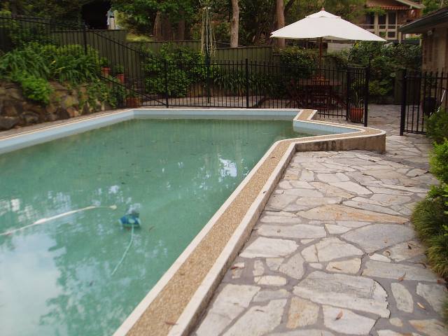 Damaged sandstone pool surrounds before